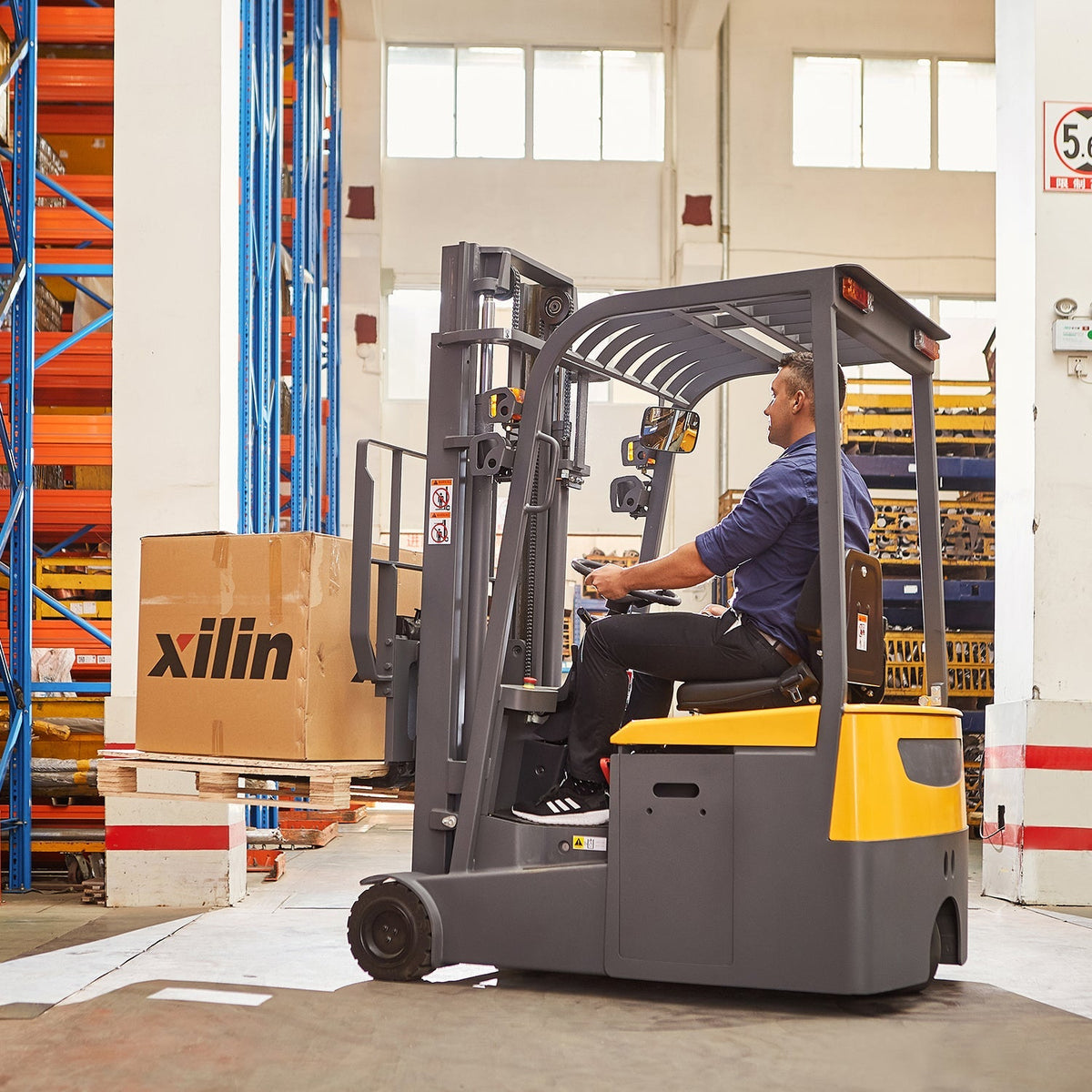 Electric forklift with gray-and-yellow body, upright mast, and operator seat