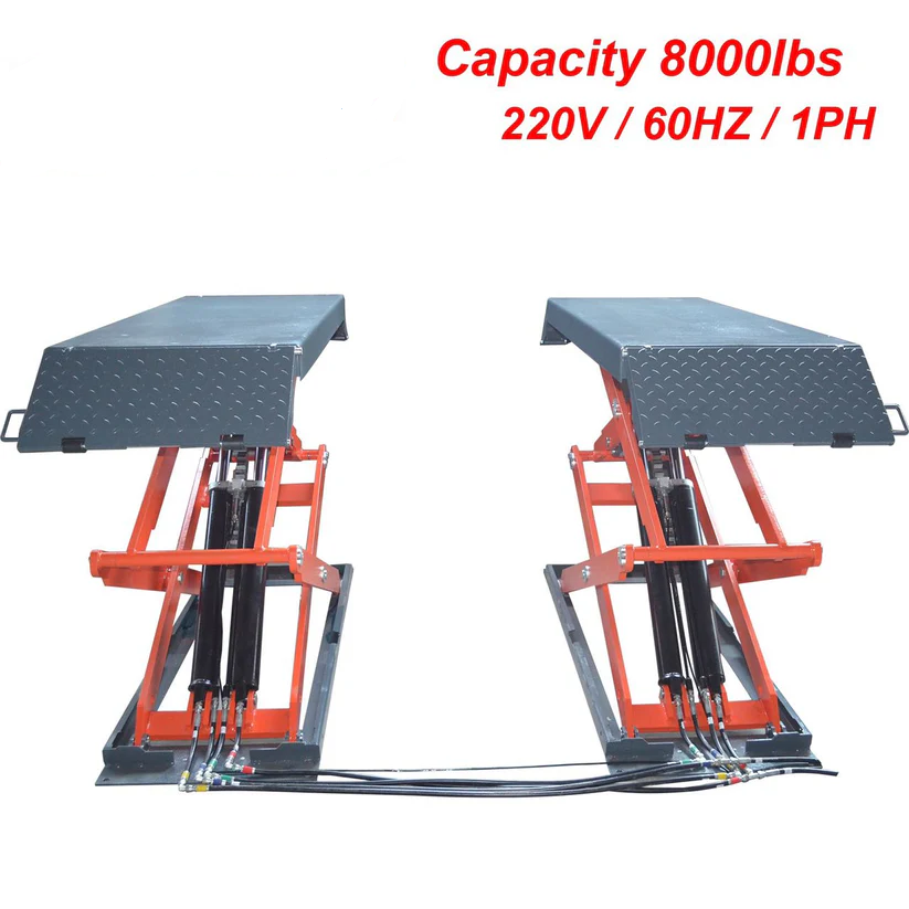In-ground scissor lift with orange scissor arms and textured black steel loading platforms