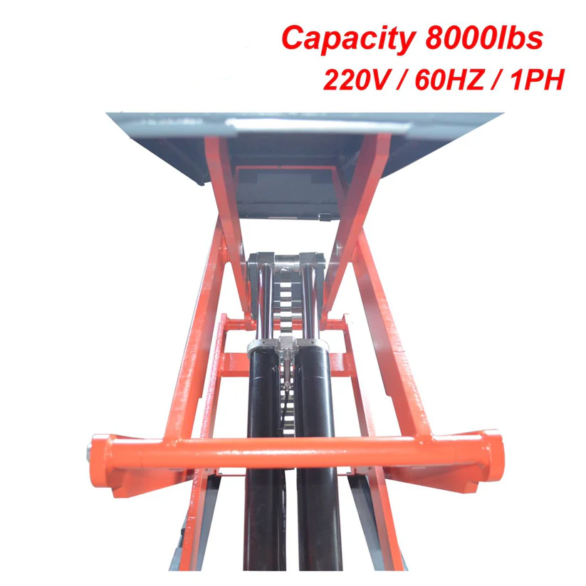 In-ground scissor lift underside view with orange frame and black hydraulic columns