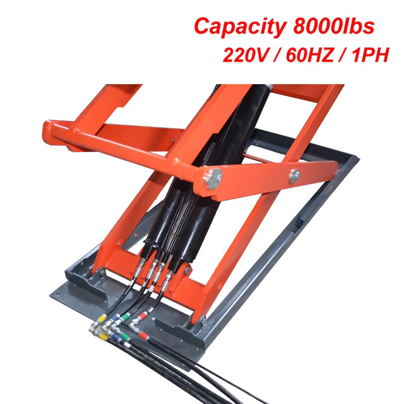 In-ground scissor lift with orange crossbeam, black lift columns, and hydraulic hoses