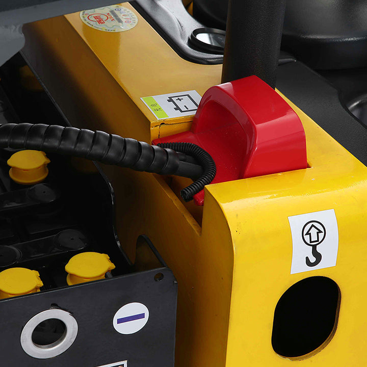 Electric pallet jack control area close-up with red emergency knob on yellow housing