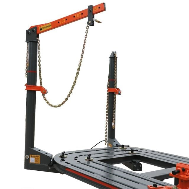 Auto body frame machine with overhead orange beam and chain hoist over base