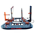 Auto body frame machine with orange clamps and black chain posts on round platform