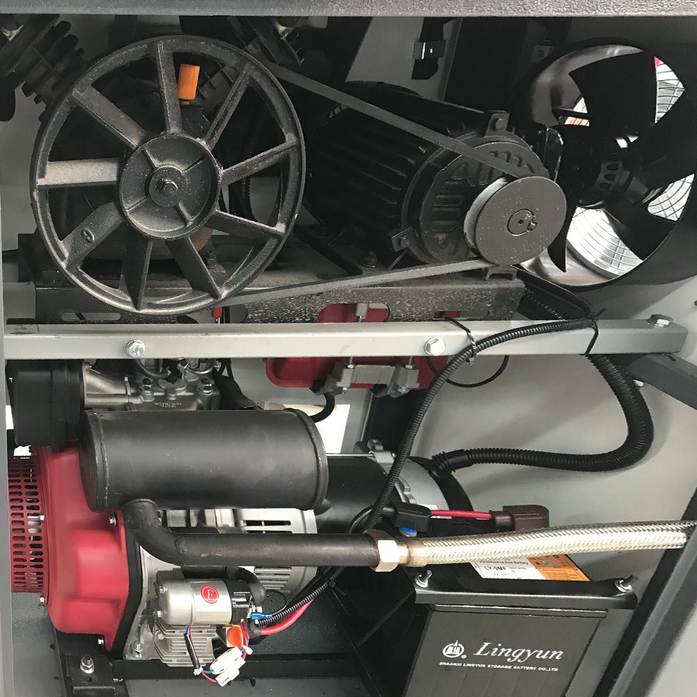 Close-up of tire changer motor, fan, hoses, and wiring inside control housing
