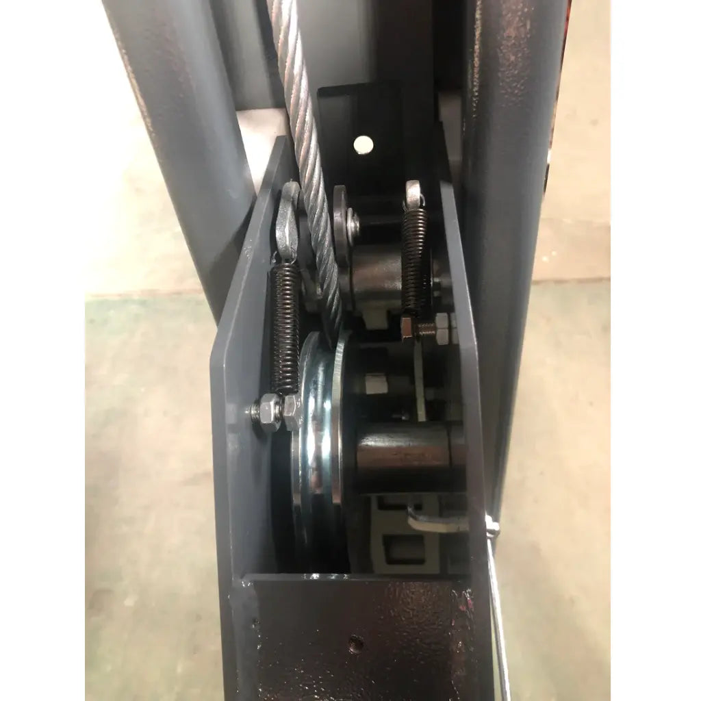 4-post vehicle lift post interior showing cables, springs, and metal pulley assembly