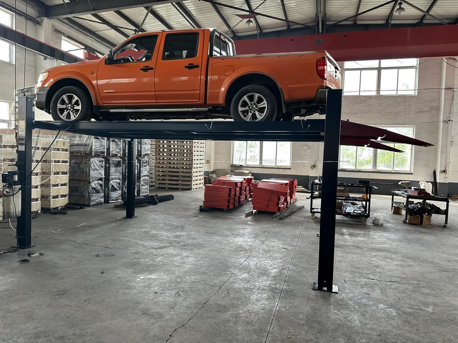 KATOOL 4-post alignment lift with orange car and red platform ramps