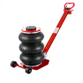 Red pneumatic air jack with stacked black air lift bags and long lifting handle