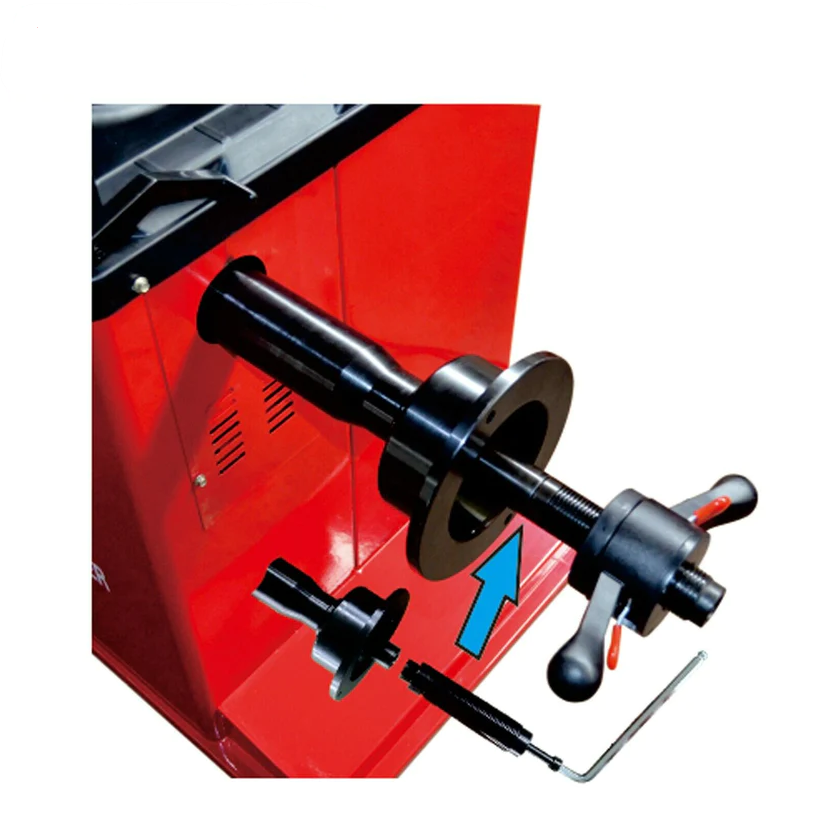 Wheel balancer spindle, flange clamp and tightening lever on red housing