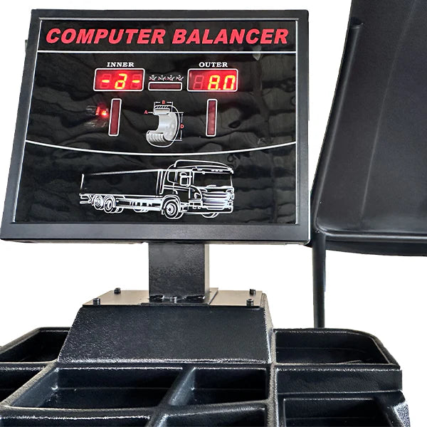 Wheel balancer control console with large screen and mounted base platform.