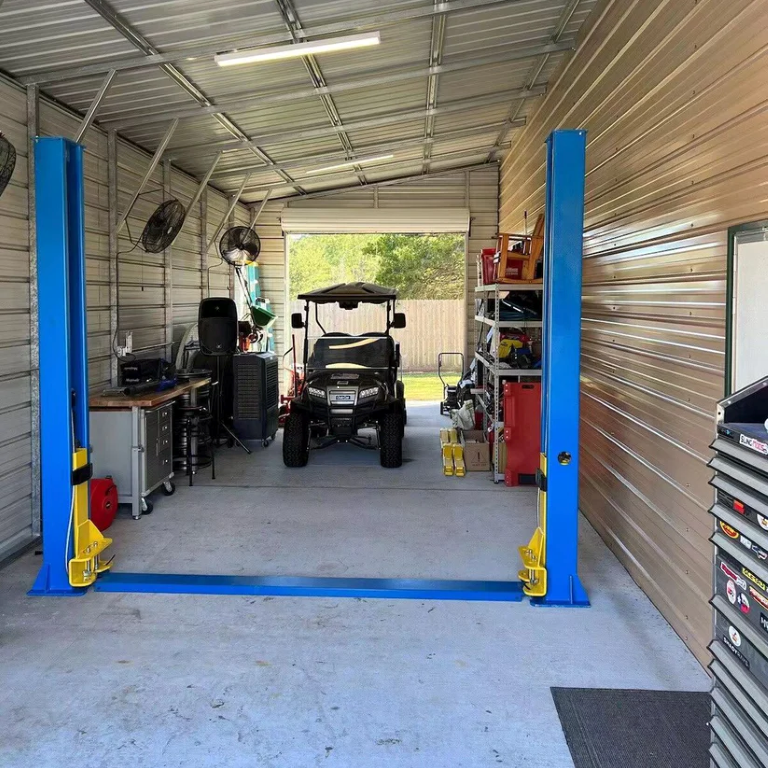 Two-post car lift with blue columns and yellow arm locks, ready for vehicle lift