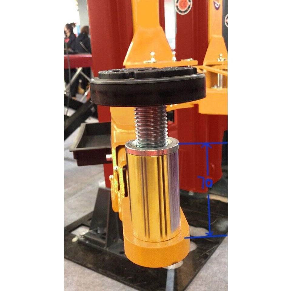 Gold hydraulic cylinder with threaded rod and black top plate on 2-post lift