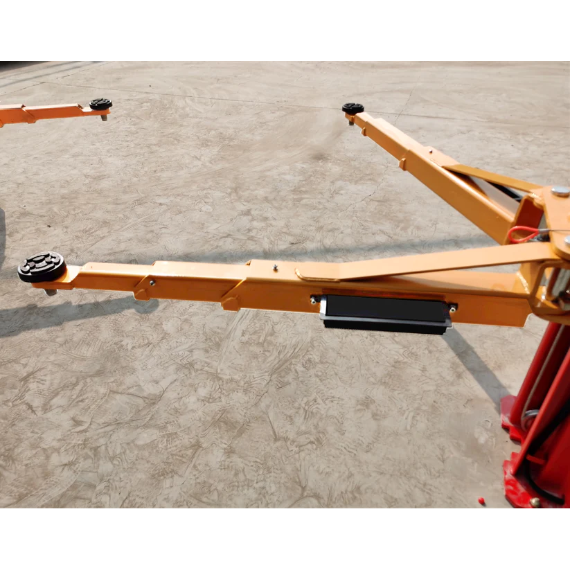 Yellow lifting beam with rubber pads and black release block on 2-post car lift