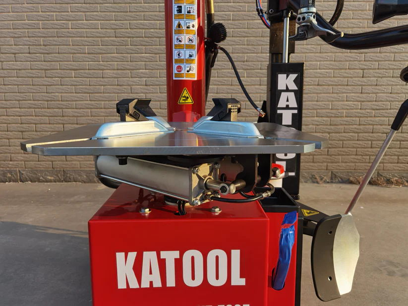 Double-arm tire changer machine with bead blaster nozzle and red base