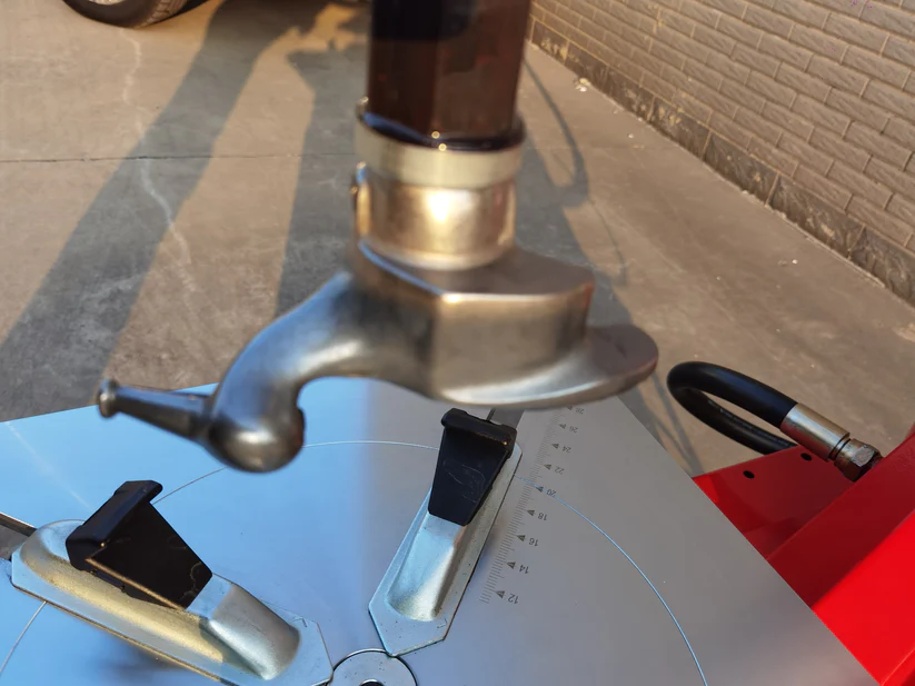 Tire changer mounting head with curved silver arm and black tool rests
