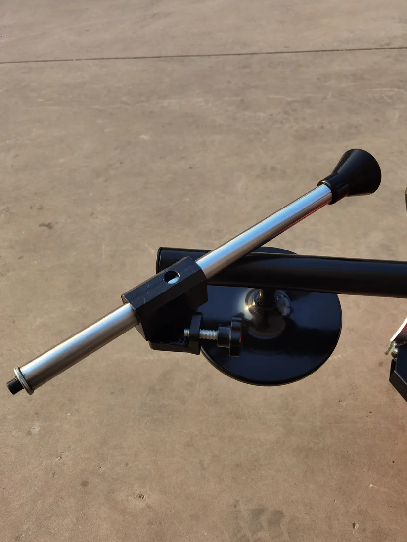 Tire changer rim-support arm with black curved bead tool and silver guide rods