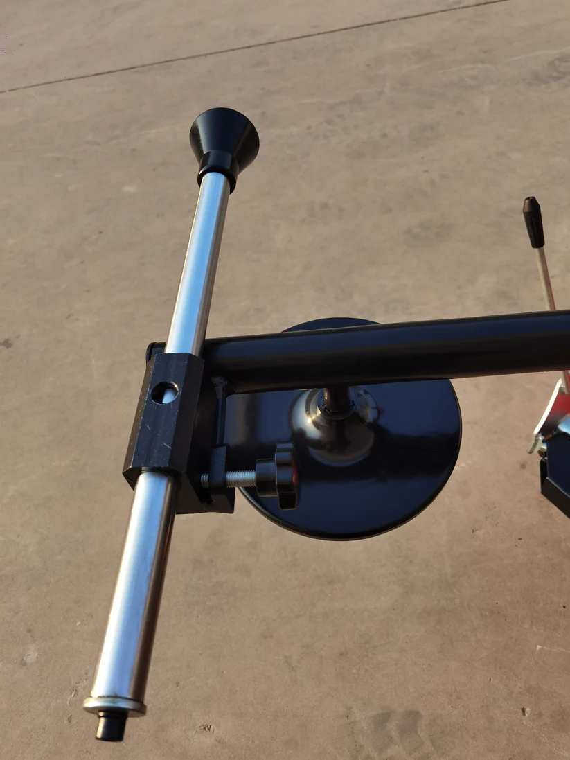 Tire changer side arm assembly with black curved bead seater and blue linkage