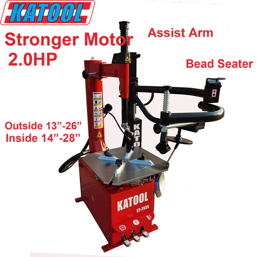 Tire changer with red housing, blue center turntable, and bead seater assist arm