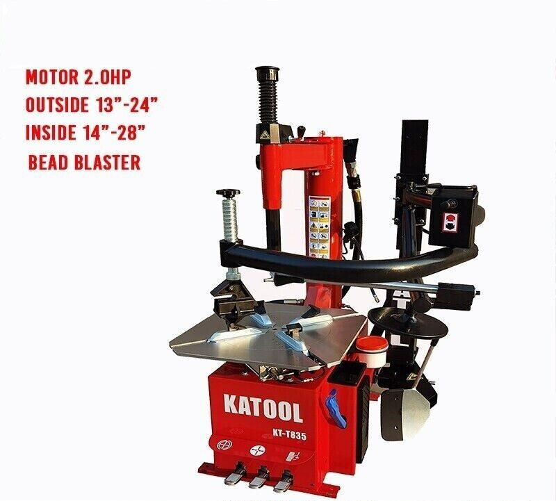 Tire changer with red body, black bead blaster arch, and spring-loaded support posts