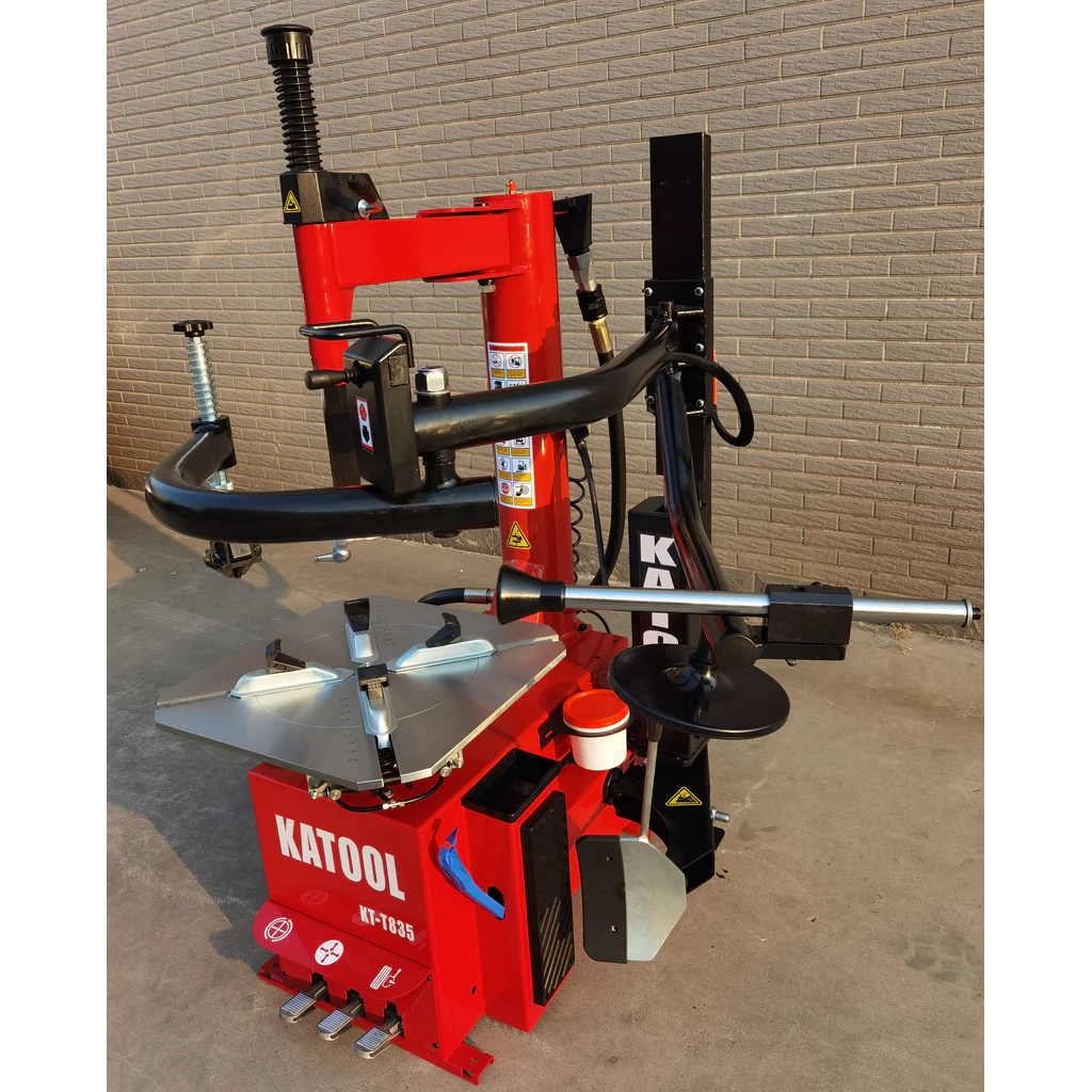 Double-arm tire changer with bead seater arm and assist post, red and black, mounted tools