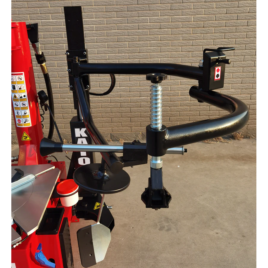 Double-arm tire changer with black bead seater arm, red base and silver turntable