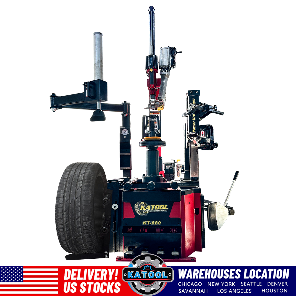 Automatic tire changer with red base and wheel mounting accessories, front view