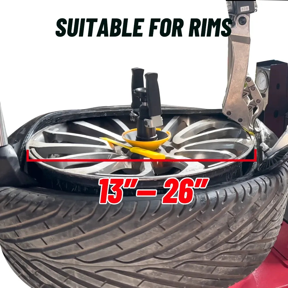 Tire changer operating on wheel; rim width marked 13–26 in