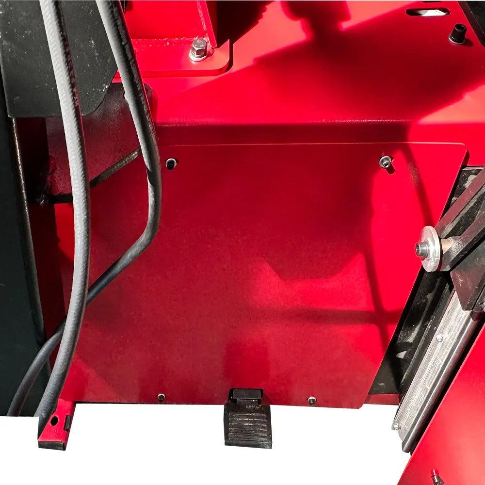 Automatic tire changer red body panel with bolts and black hoses, close-up
