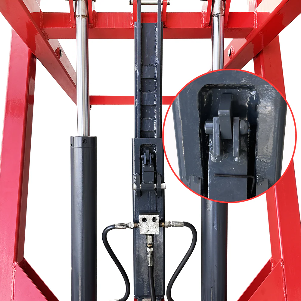 Hydraulic lift cylinder and black valve assembly on a red scissor lift frame