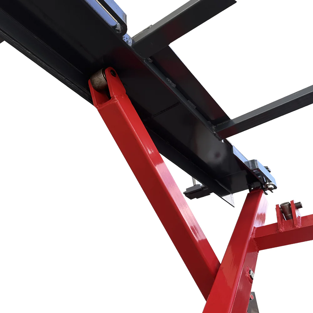 Close-up of red and black scissor lift linkage and mounting bracket under the platform
