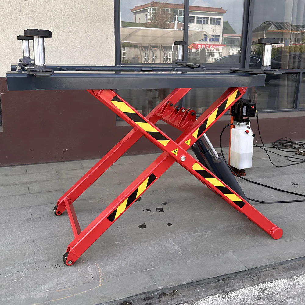 Red scissor lift base with black platform and yellow hazard stripe cross braces