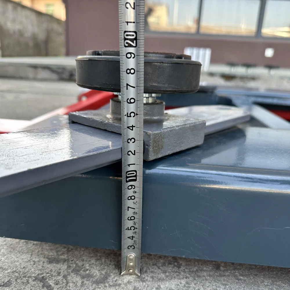 Height measurement on scissor lift platform with ruler and black rubber pad