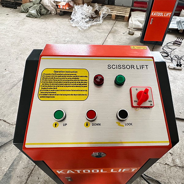 Orange control unit for a scissor lift with red and green push buttons