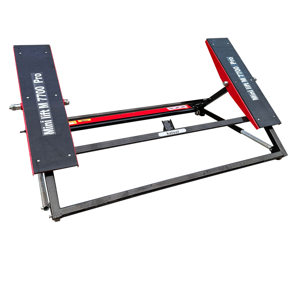 Tilting floor car jack with angled black lift arms and red trim along the frame