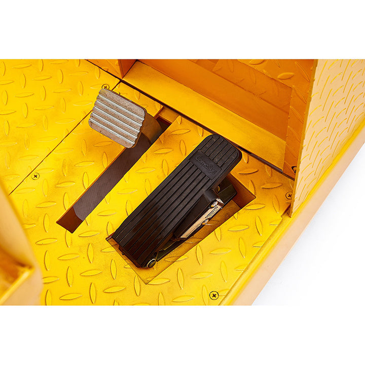Yellow tow tractor foot pedals and rubber tread step platform, close-up