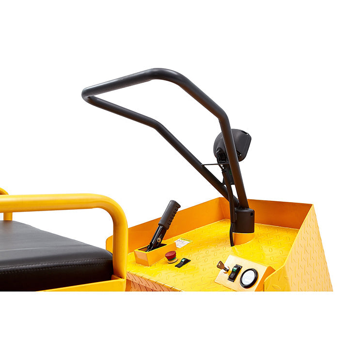 Yellow tow tractor control area with black steering handle and armrest, close-up