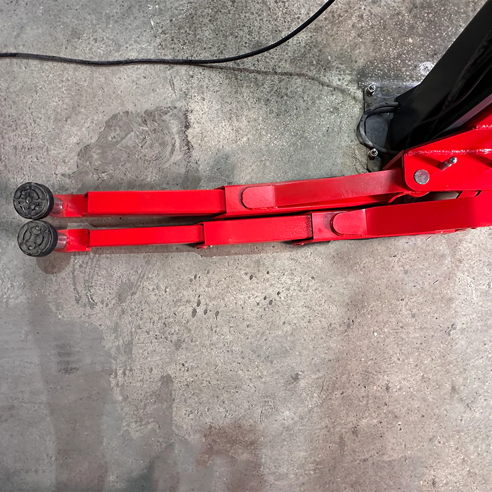 Red lift arm assembly with black roller pads and base joint