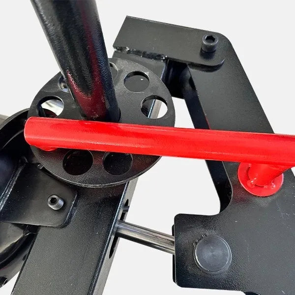 Close-up of mini tire changer clamp area with red bar and black mounting brackets