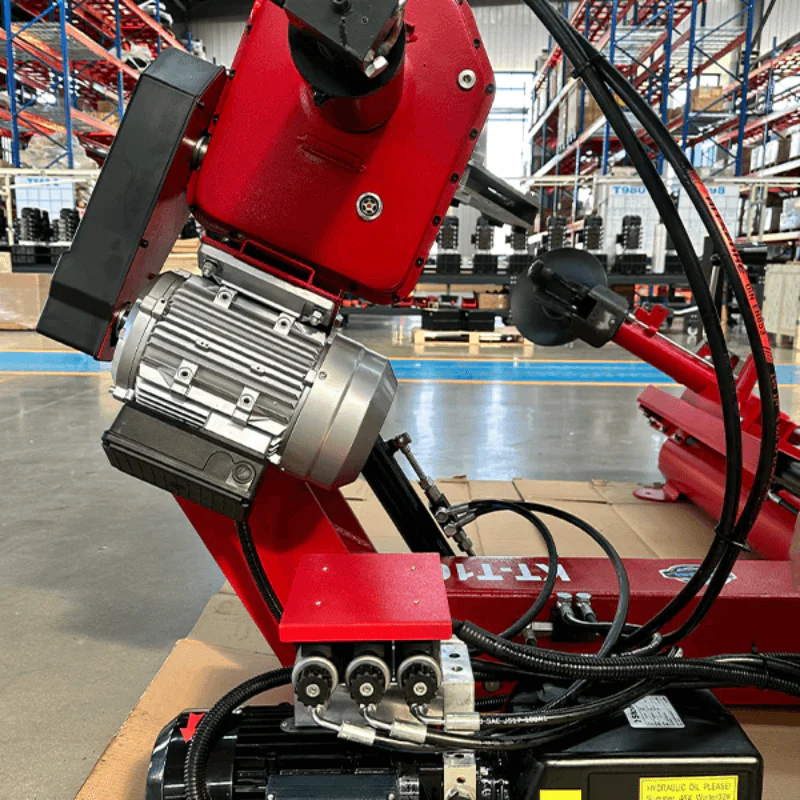 Red tire changer motor unit with hoses and black control handle on base