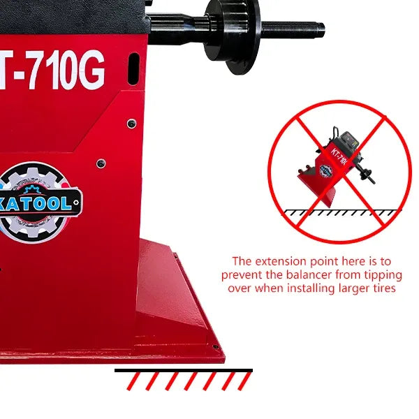 Wheel balancer base with extension point, red safety markings, and stabilizing feet