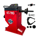 Portable wheel balancer with red housing, black console, spindle shaft, and mounting clamps