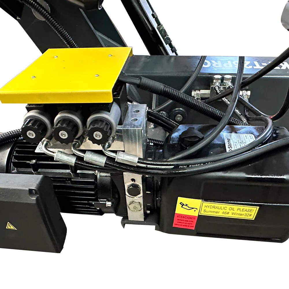 Hydraulic tire changer assembly with black motor area, hoses, and warning label
