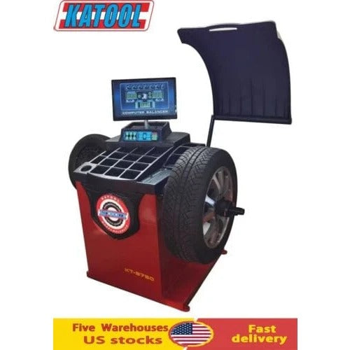 Wheel balancer with computer display, dark blue shield, and red housing for tire balancing