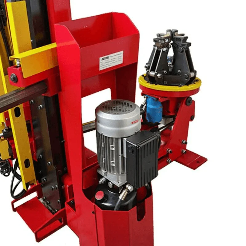 Red tire changer housing with motor unit and wheel clamp on rotating base