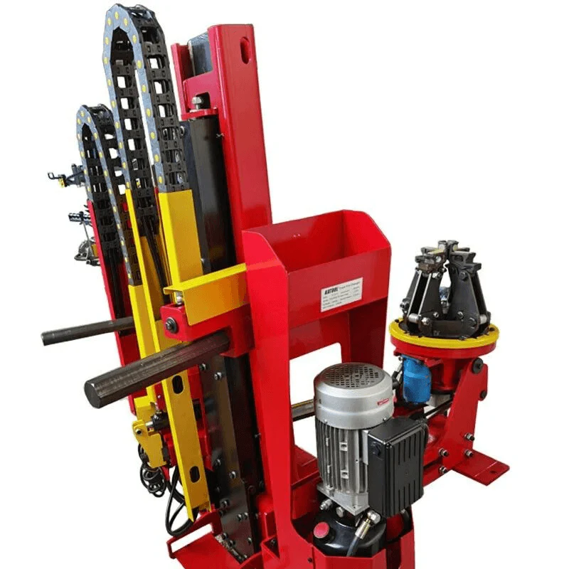 Tire changer and balancer assembly with red frame, wheel clamp, and yellow guides