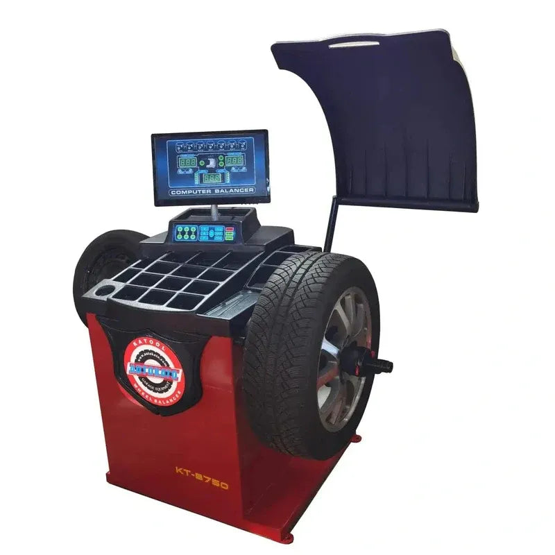 Red tire balancer machine with digital display and black hood guard