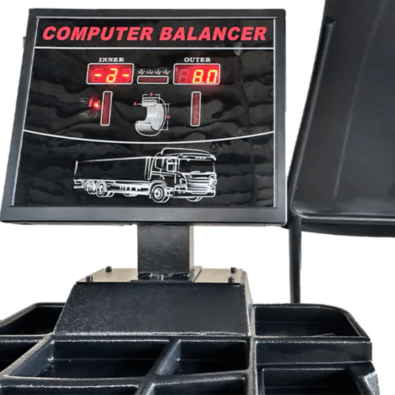 Wheel balancer computer display with red LED readouts and instruction graphic