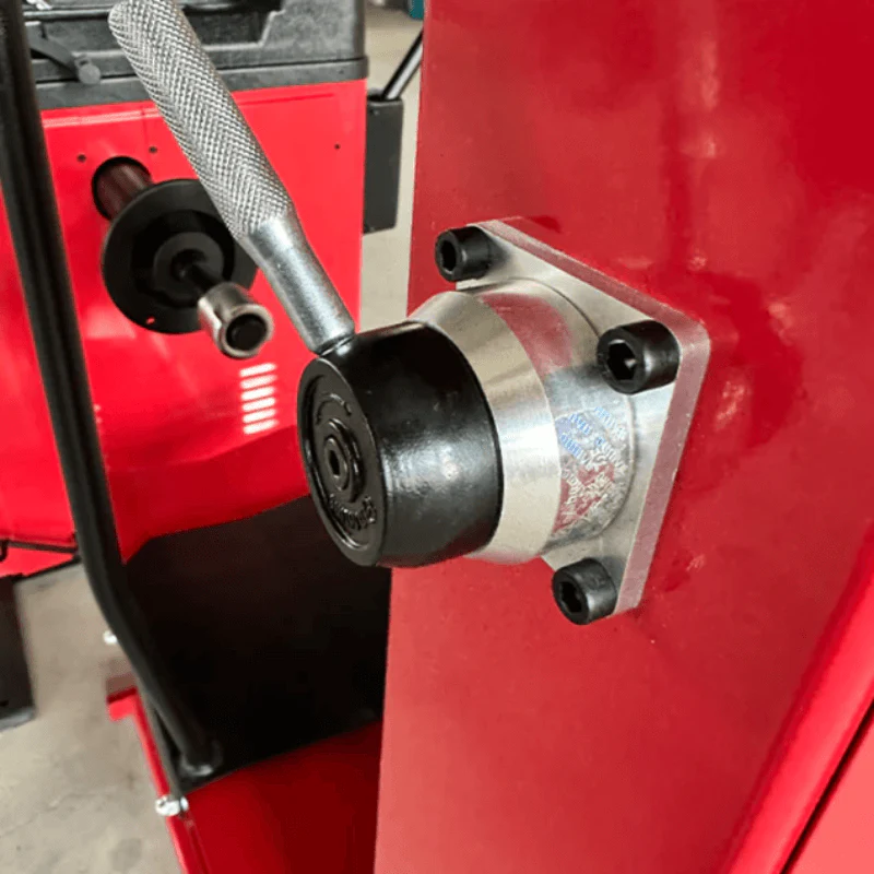 Tire balancer spindle housing with metallic hub and red machine frame