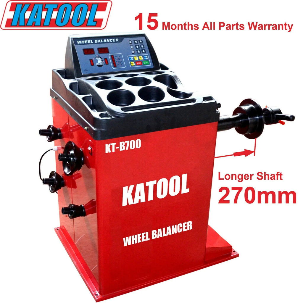 Wheel balancer machine with red housing, black gauge console, and multi-hole rim plate