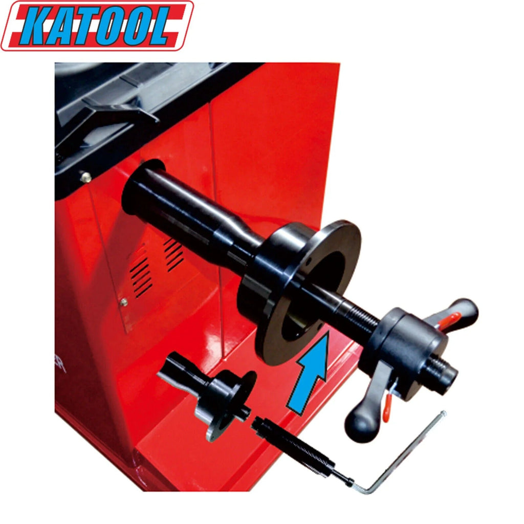 Wheel balancer adjustment shaft with black knobs mounted on red machine housing