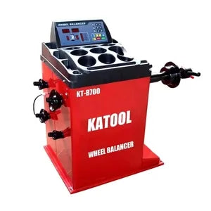 Katool wheel balancer with red housing, control console, and mounted tire